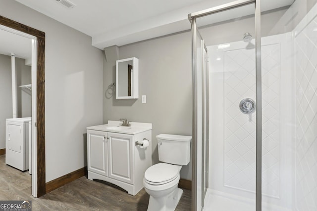 full bathroom with a shower stall, washer / clothes dryer, and wood finished floors