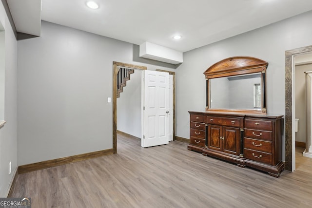 unfurnished bedroom featuring light wood-style flooring, recessed lighting, and baseboards