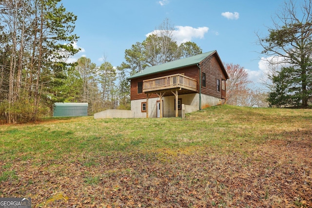 back of property with a yard and a deck