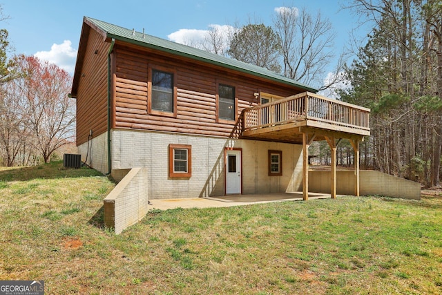 rear view of property with central AC unit, a wooden deck, a yard, a patio area, and metal roof