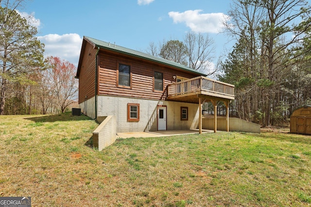 rear view of house featuring an outdoor structure, central air condition unit, a storage unit, and a lawn