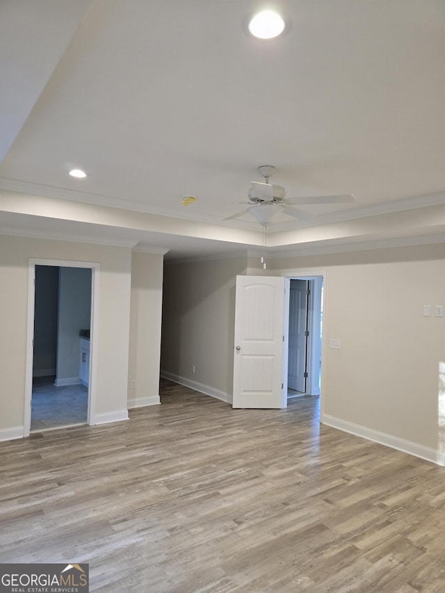 interior space featuring light wood-style flooring, baseboards, and a ceiling fan