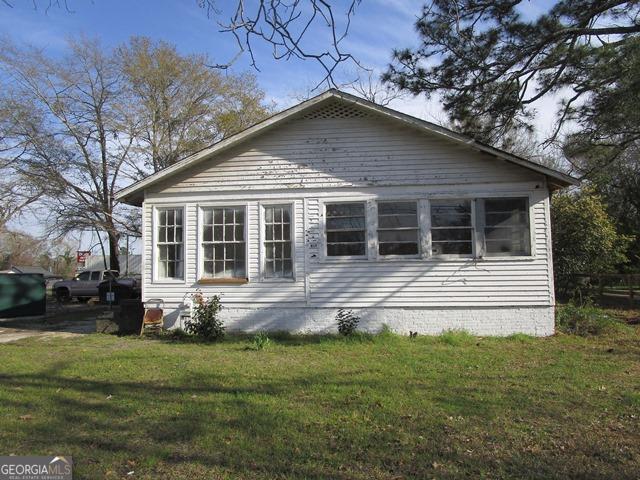 view of side of home featuring a yard