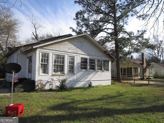 view of home's exterior with a lawn