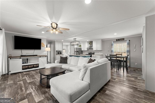 living area with dark wood-type flooring, recessed lighting, a ceiling fan, and ornamental molding