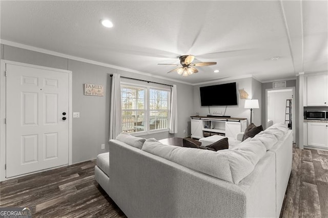 living room with a ceiling fan, dark wood-type flooring, crown molding, and a textured ceiling