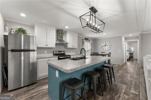 kitchen featuring a sink, wall chimney range hood, white cabinets, stainless steel appliances, and dark wood-style flooring