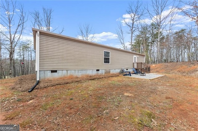 view of property exterior with crawl space