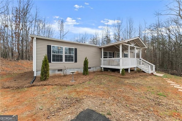 view of front of home with crawl space and a porch