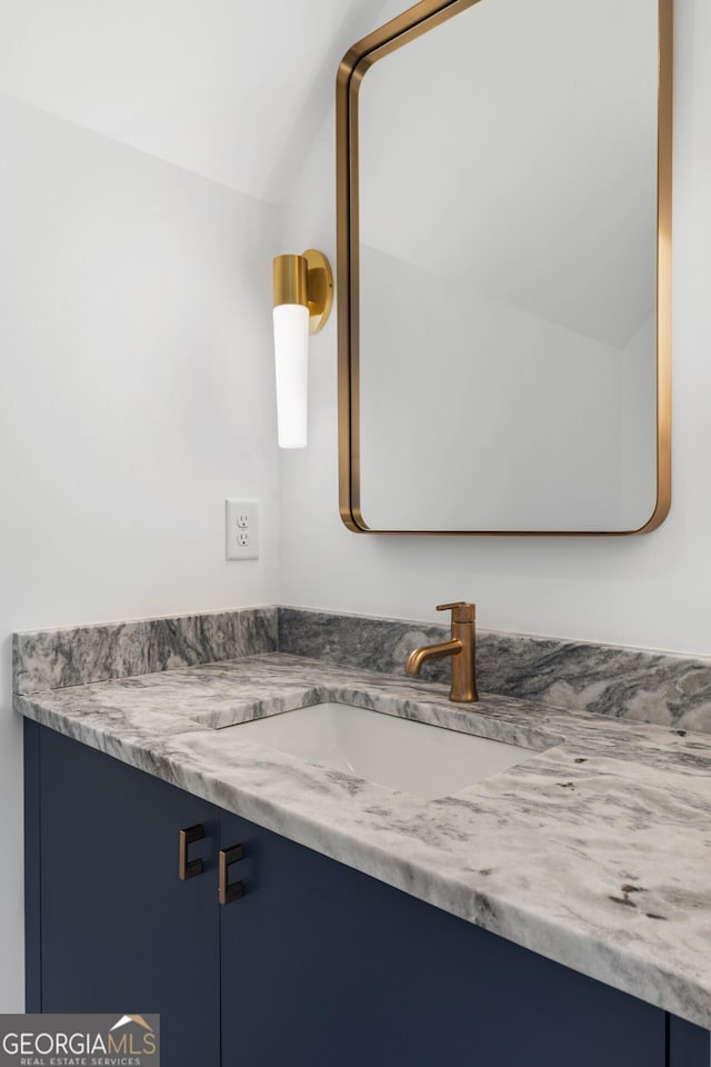 bathroom featuring vanity and vaulted ceiling