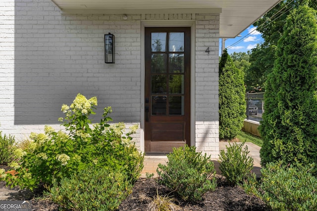 property entrance featuring brick siding