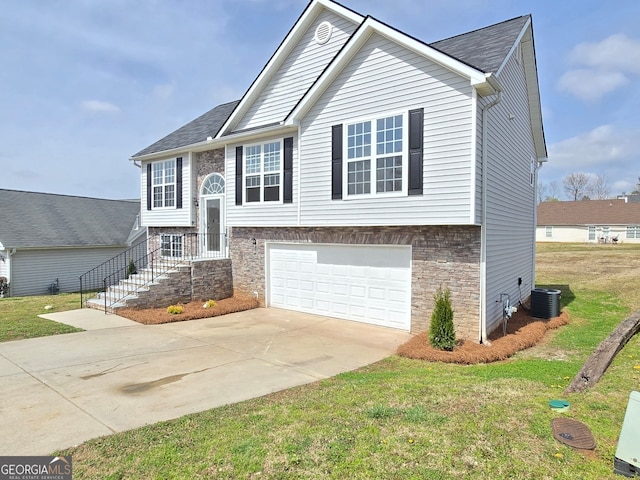 split foyer home with a front yard, central air condition unit, an attached garage, and driveway