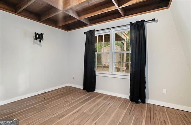 spare room with wood finished floors, baseboards, and coffered ceiling