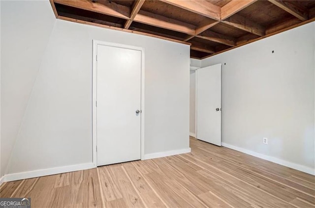 interior space featuring baseboards and light wood-style flooring