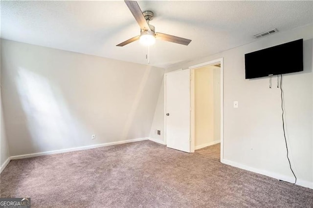 unfurnished bedroom featuring visible vents, baseboards, ceiling fan, carpet flooring, and a textured ceiling