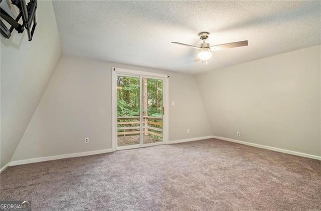 interior space featuring a textured ceiling, baseboards, carpet floors, and ceiling fan