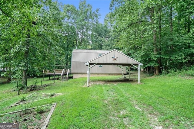 view of yard featuring a carport and a garden