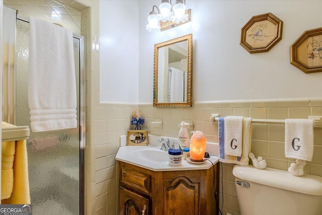 bathroom with a notable chandelier, a stall shower, tile walls, and vanity