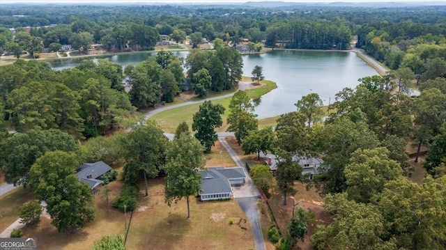 aerial view with a forest view and a water view