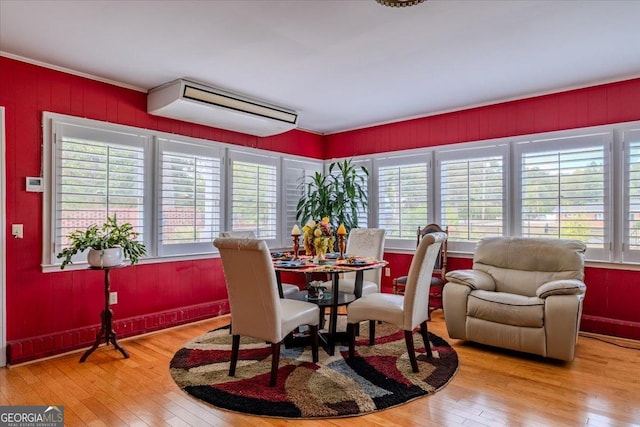 dining room featuring a healthy amount of sunlight and wood-type flooring