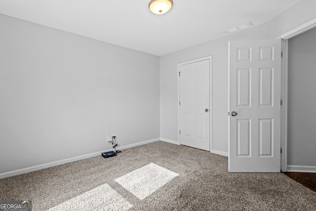 unfurnished bedroom featuring visible vents, carpet, and baseboards