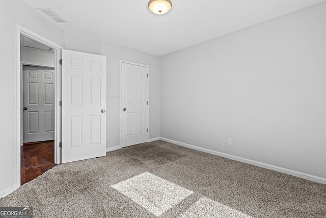 unfurnished bedroom featuring visible vents, carpet floors, and baseboards