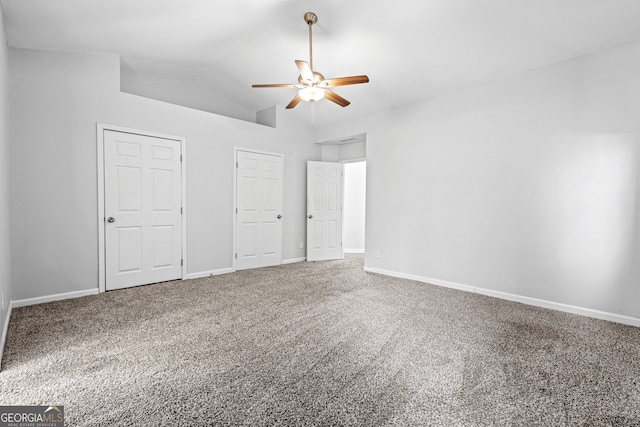 unfurnished bedroom featuring vaulted ceiling, carpet flooring, baseboards, and ceiling fan