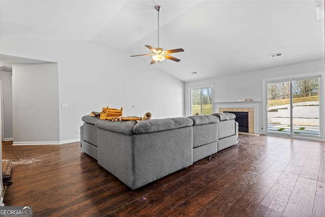 living room featuring ceiling fan, visible vents, lofted ceiling, and hardwood / wood-style floors