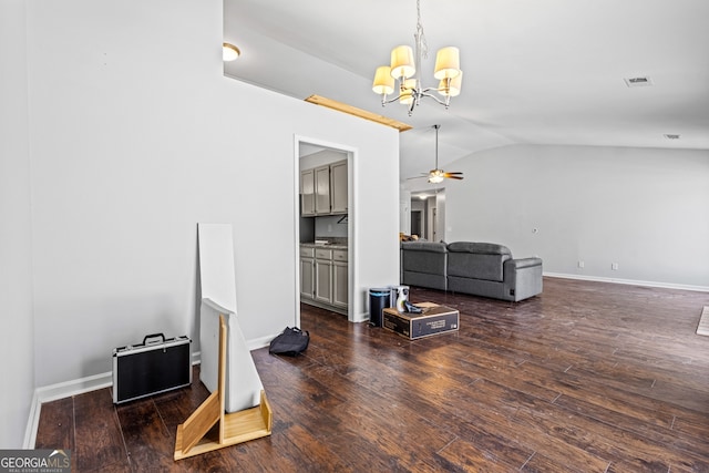 living room featuring hardwood / wood-style floors, visible vents, baseboards, vaulted ceiling, and ceiling fan with notable chandelier