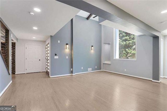 interior space featuring a fireplace, recessed lighting, wood finished floors, and baseboards