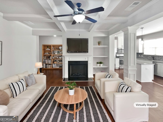 living area featuring a fireplace with flush hearth, wood finished floors, coffered ceiling, and ceiling fan