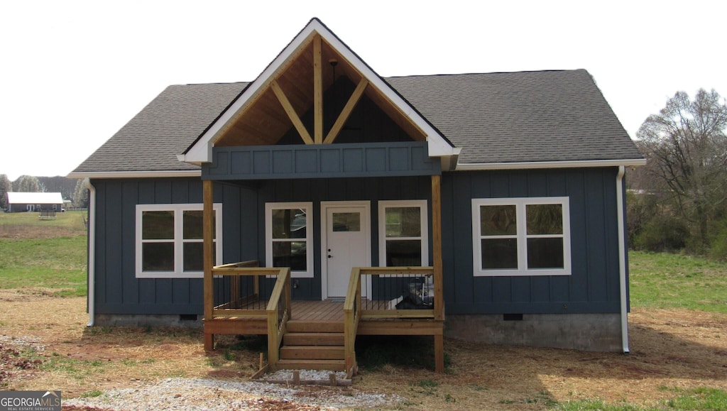 view of front of property featuring a porch, crawl space, board and batten siding, and a shingled roof