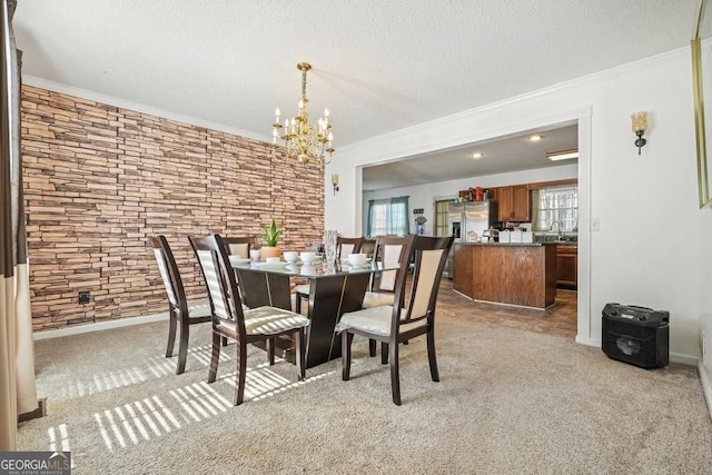 dining room featuring crown molding, light carpet, and a notable chandelier