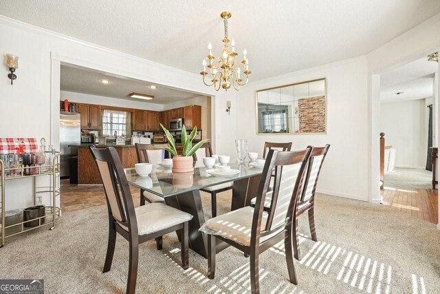 dining room with an inviting chandelier, light carpet, and ornamental molding
