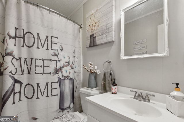 bathroom featuring a textured ceiling, a shower with curtain, vanity, and toilet