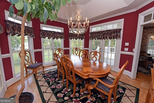 dining area featuring an inviting chandelier, light wood-style flooring, and ornamental molding