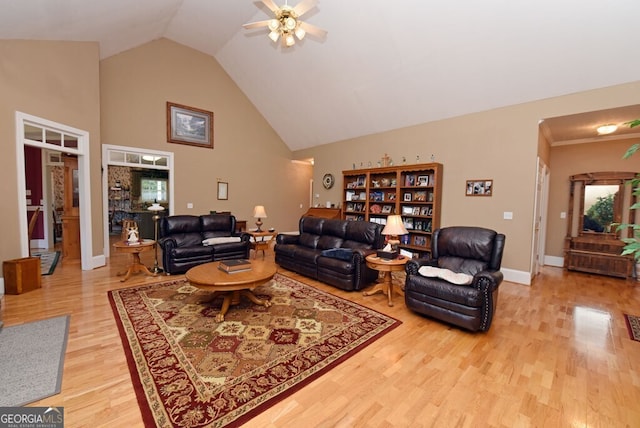 living room with baseboards, high vaulted ceiling, light wood-type flooring, and ceiling fan