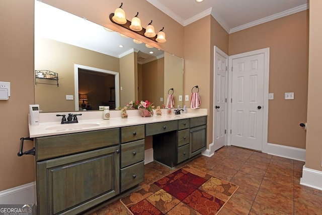 full bath featuring a sink, baseboards, double vanity, and crown molding