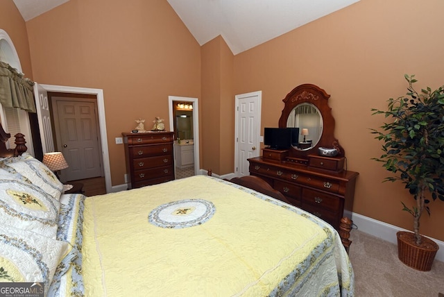 bedroom featuring baseboards, high vaulted ceiling, ensuite bathroom, and carpet