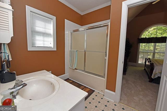 bathroom with baseboards, bath / shower combo with glass door, ornamental molding, and vanity