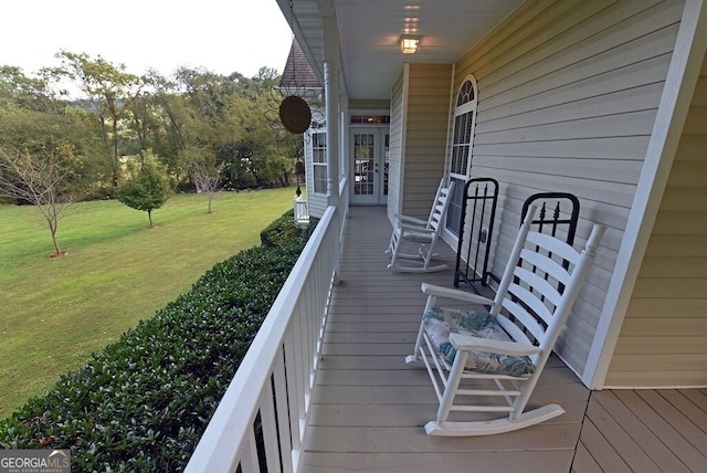 wooden terrace featuring a yard