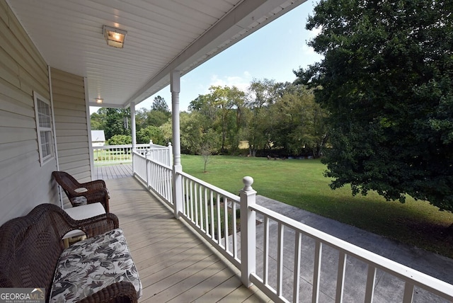 deck featuring a porch and a lawn