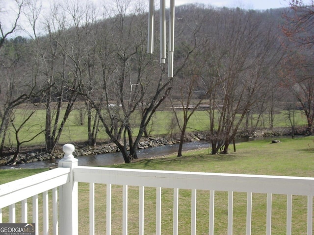 exterior space featuring a yard and a view of trees