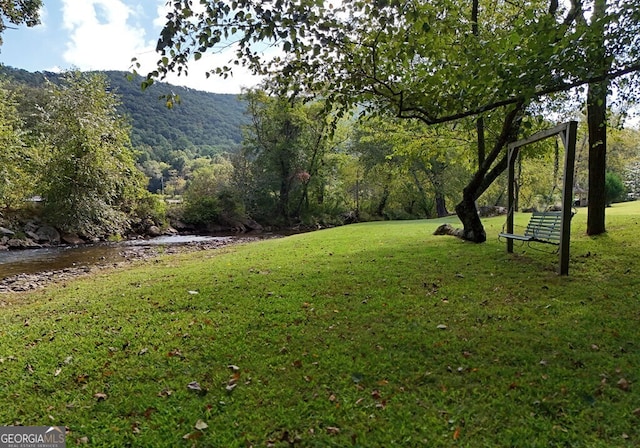 view of yard with a view of trees