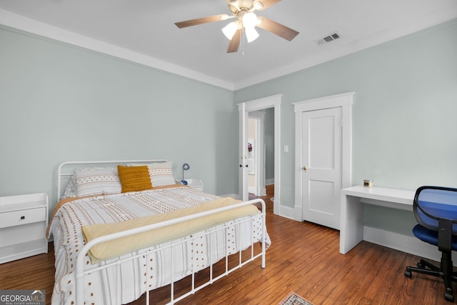 bedroom with visible vents, a ceiling fan, baseboards, and wood finished floors