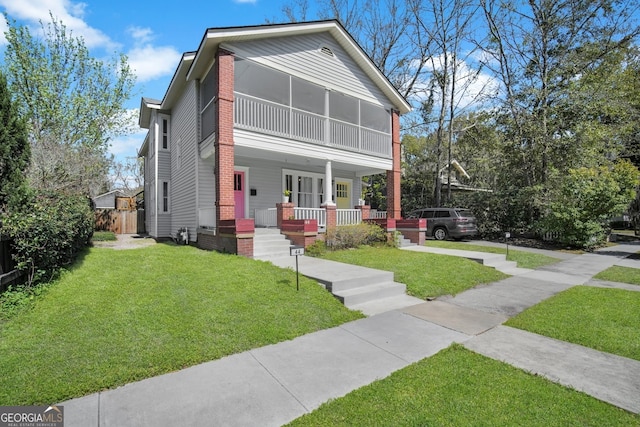 view of front of property with covered porch and a front lawn