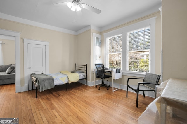 bedroom with baseboards, light wood-style floors, and ceiling fan