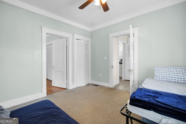 bedroom with a ceiling fan, carpet, and baseboards