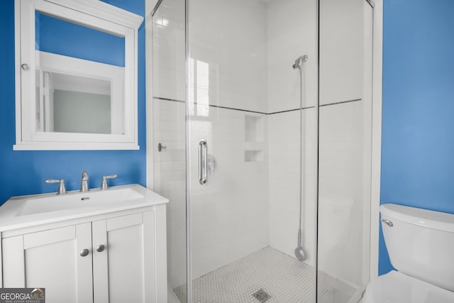 full bathroom with vanity, toilet, and a stall shower