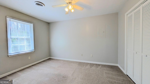 unfurnished bedroom with visible vents, ceiling fan, baseboards, carpet, and a closet